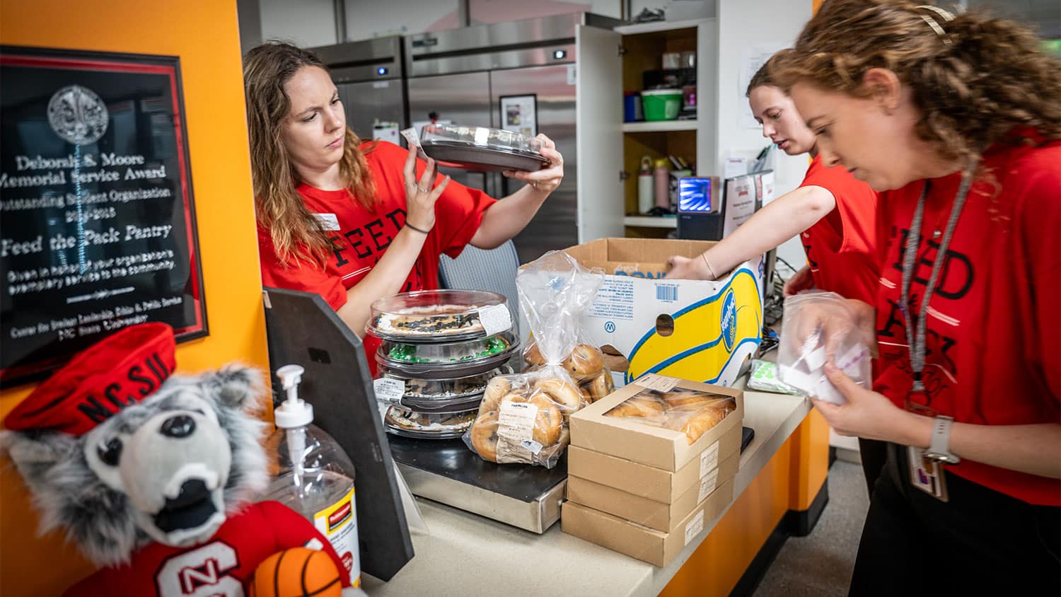 NC State Students packing supplies for pack essentials to donate