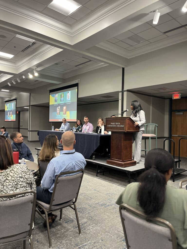 Five expert professionals sitting on a panel facilitated by Tameka Singleton